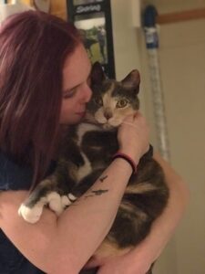 cat cuddled by owner